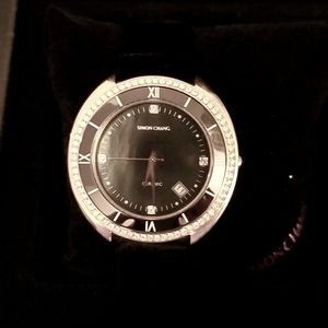 Simon Chang women watch.  Pink gold with black mother of pearl interior.